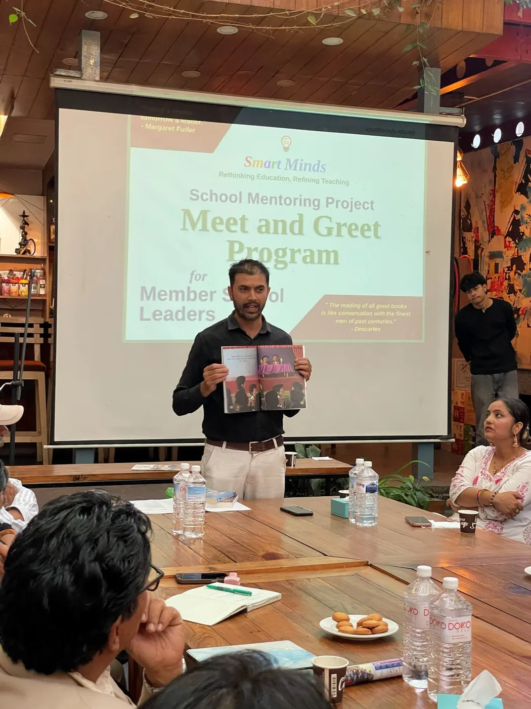 A participant presents a book at the Smart Minds SMP Meet & Greet, celebrating reading culture